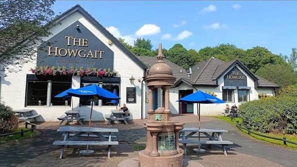 The Howgait in Glasgow on a sunny day, with benches and umbrellas out front